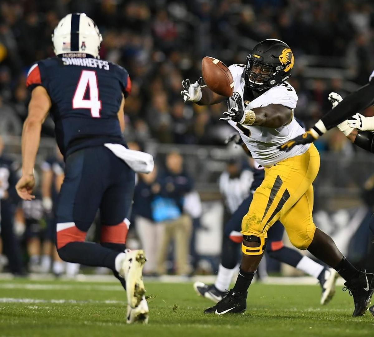 Missouri defensive lineman Terry Beckner Jr. (right), an East St. Louis High School graduate, blocks a pass by Connecticut quarterback Bryant Shirreffs during the first half of an Oct. 28 game in East Hartford, Conn.