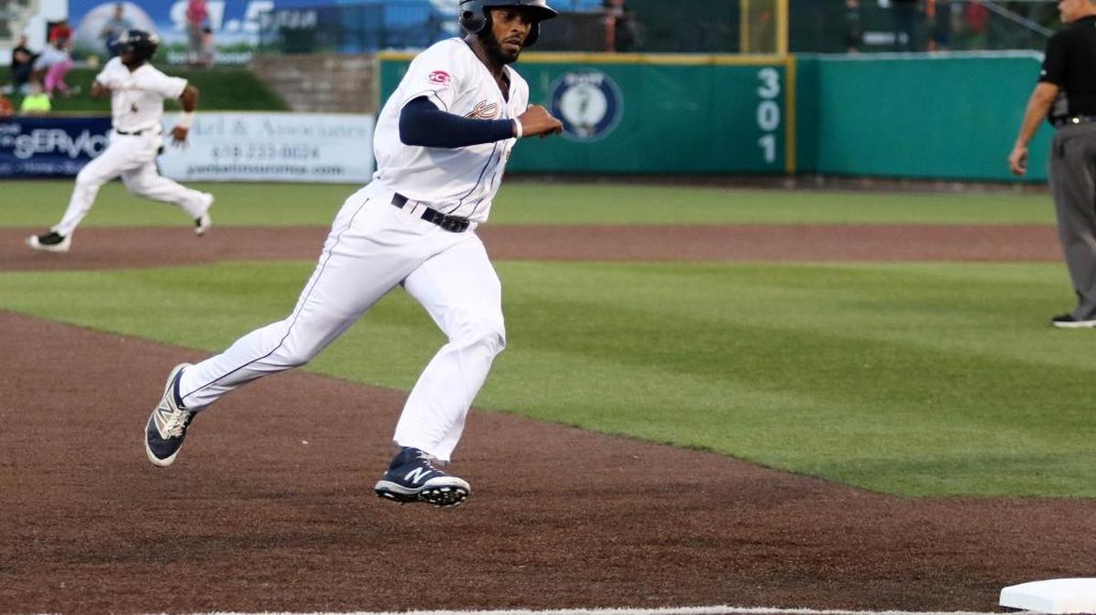 The Grizzlies’ Blake Brown looks to score after Terry McClure scored on a bases-loaded double by Joel McKeithan in the fourth inning against Evansville.