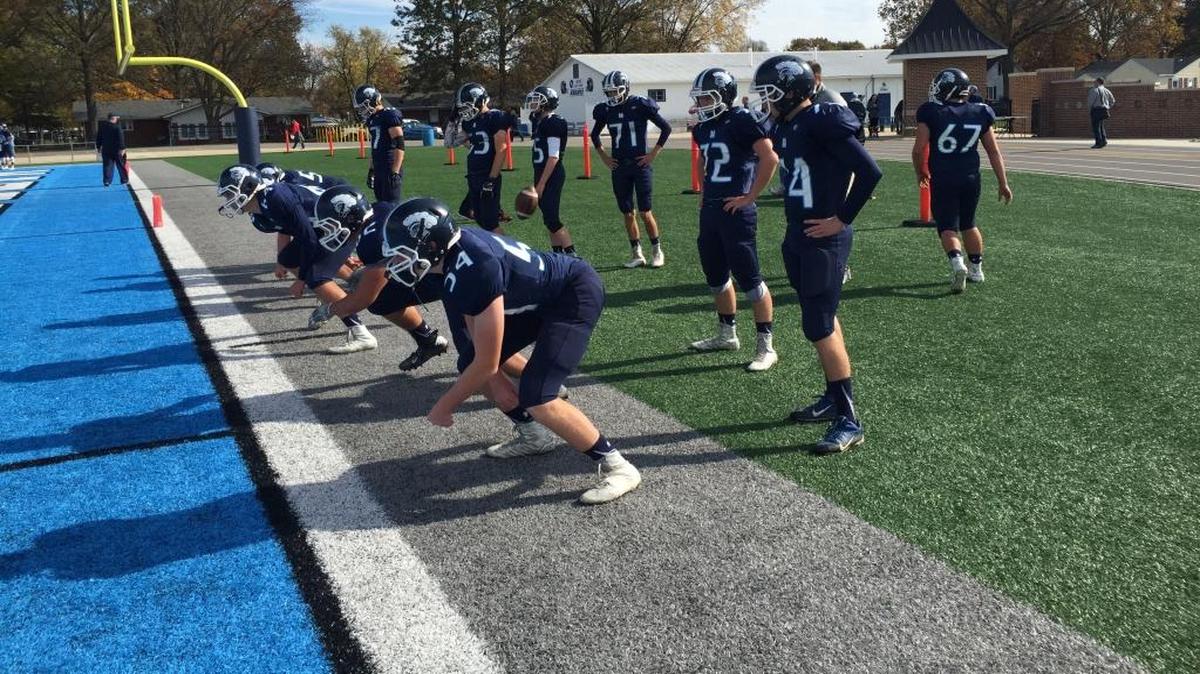 Mater Dei football players warm up before their playoff matchup Saturday against Columbia