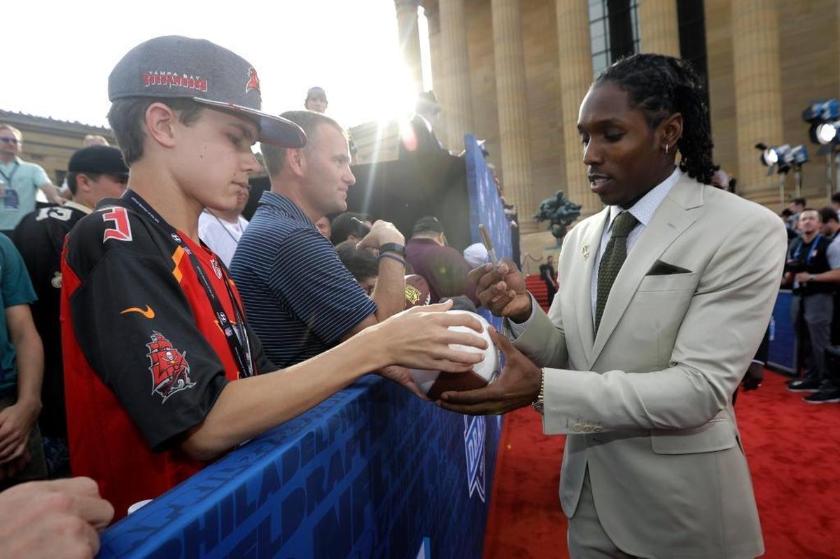 Southern California's Adoree' Jackson signs autographs for fans before the first round of the 2017 NFL football draft, Thursday, April 27, 2017, in Philadelphia.