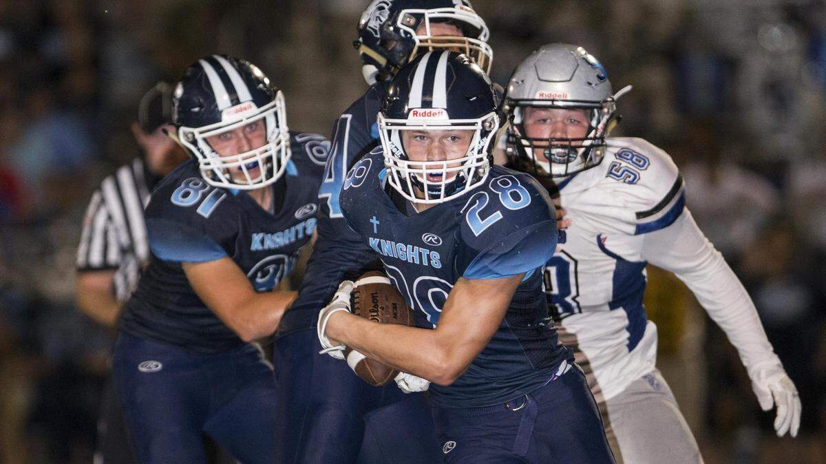 Mater Dei’s Logan Ratermann carries the ball during the Freeburg-Mater Dei game Friday night in Breese.