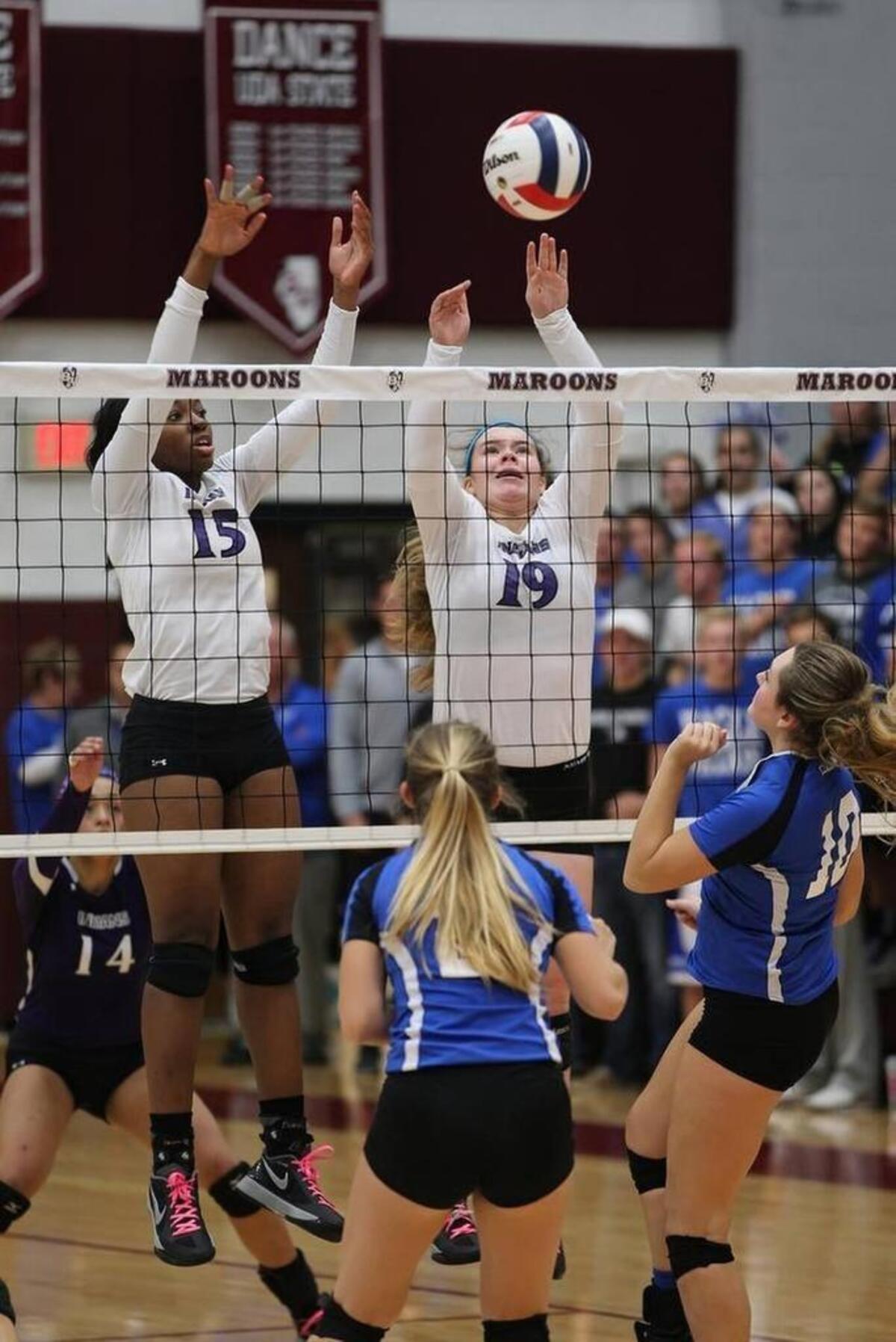 In this BND file photo, Mascoutah’s Katirah Johnson (15) and Tieghan Morio (19) jump to block the ball against Columbia during a sectional championship game at Belleville West High School on Nov. 5, 2015.