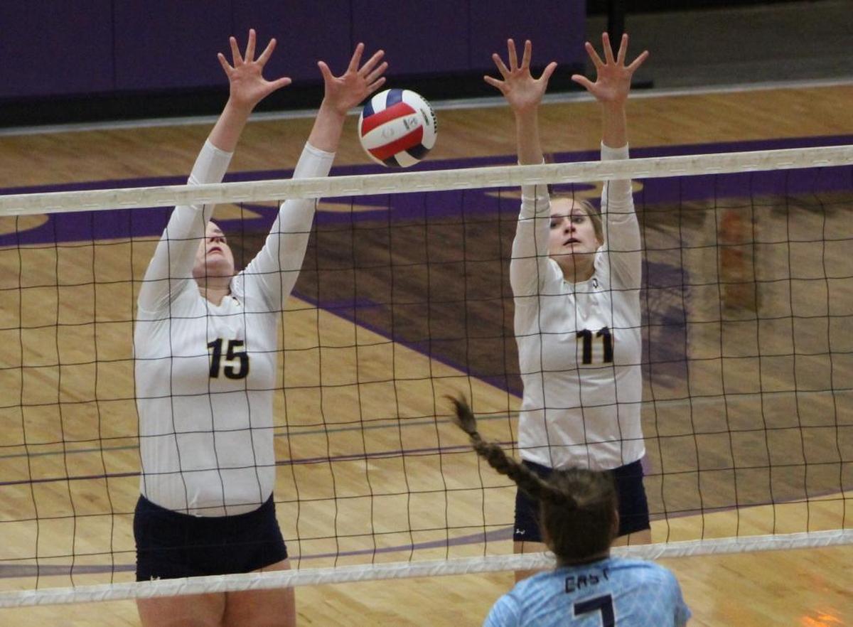 O’Fallon senior Hannah Bell and junior Katherine Toftemark block an attempted kill by Belleville East sophomore Brooke Haas during the Collinsville Regional championship game Thursday.