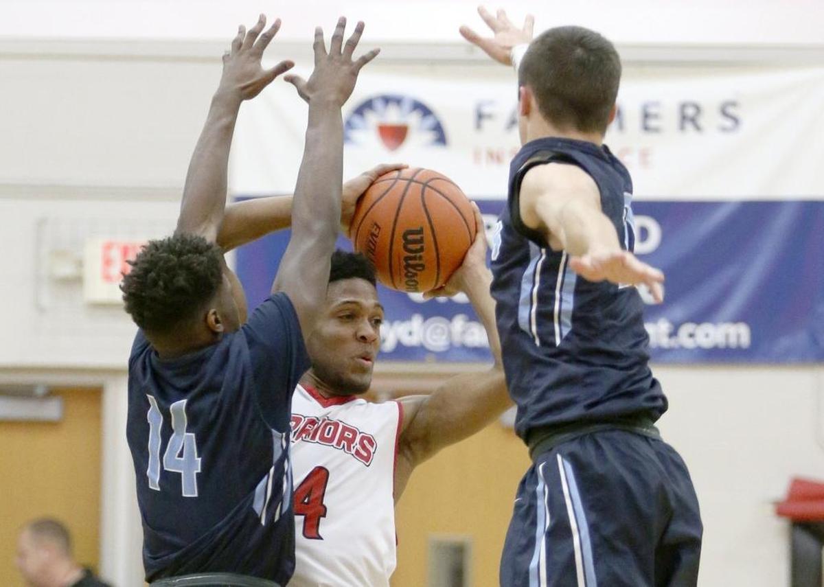 Granite City’s Ronn Allen looks for an outlet against Belleville East defenders Isaiah King and Drew Millas during a SWC game earlier this season. The Warriors will be leaving the conference after next season.