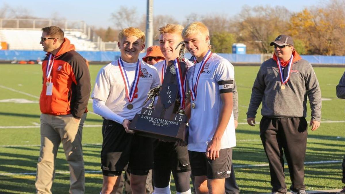 Waterloo captains Cole Kaiping, Chase Rubemeyer and Kane Osterhage with the Class 2A state championship trophy. Waterloo won the state championship with a 4-3 victory versus Peoria Notre Dame.