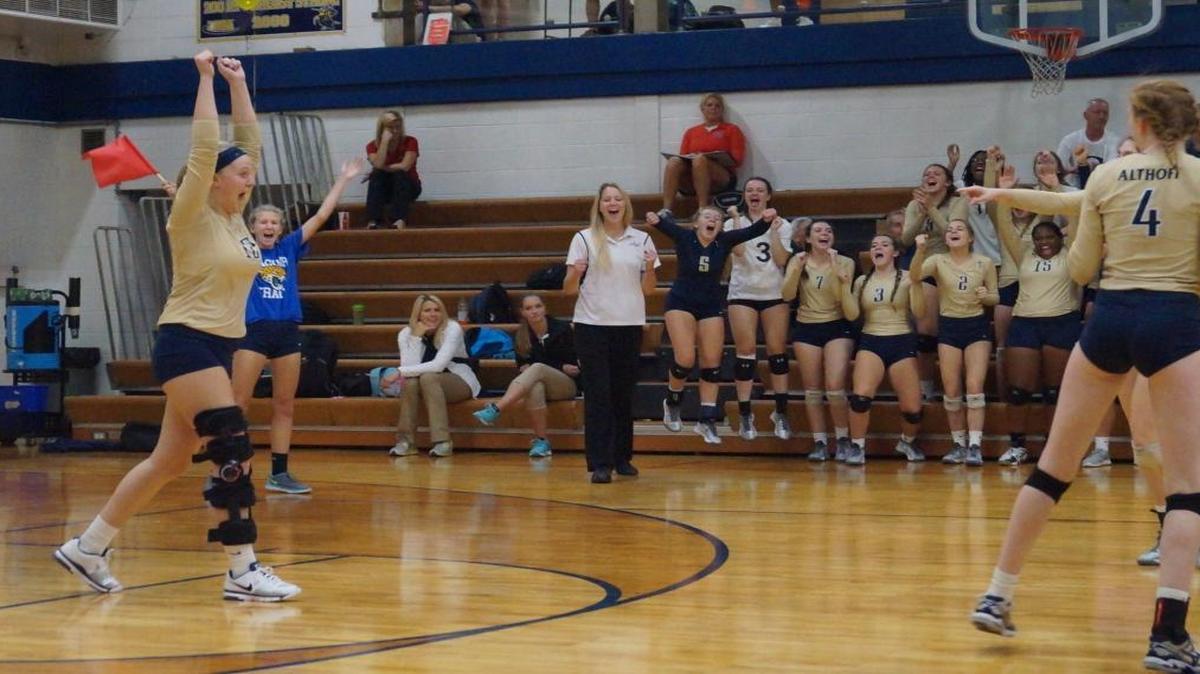 
Althoff’s Rachel Mertens celebrates a point with her teammates.
