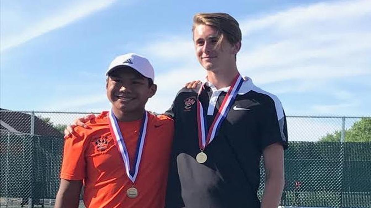 Edwardsville sophomore Zach Trimpe (left) and junior Alex Gray with their medals after winning the IHSA Class 2A state tennis doubles title Saturday, May 27, 2017.
