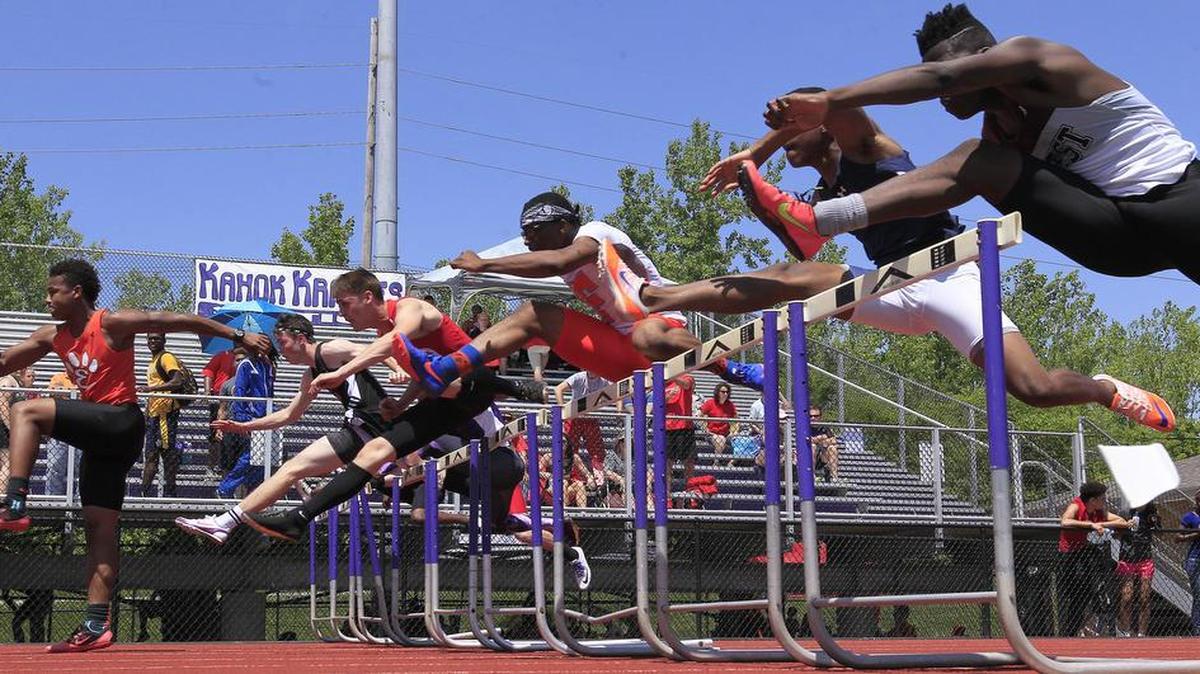 Hurdlers fly past in this heat of the 110 meter hurdles at the Collinsville Invitational Track Meet.