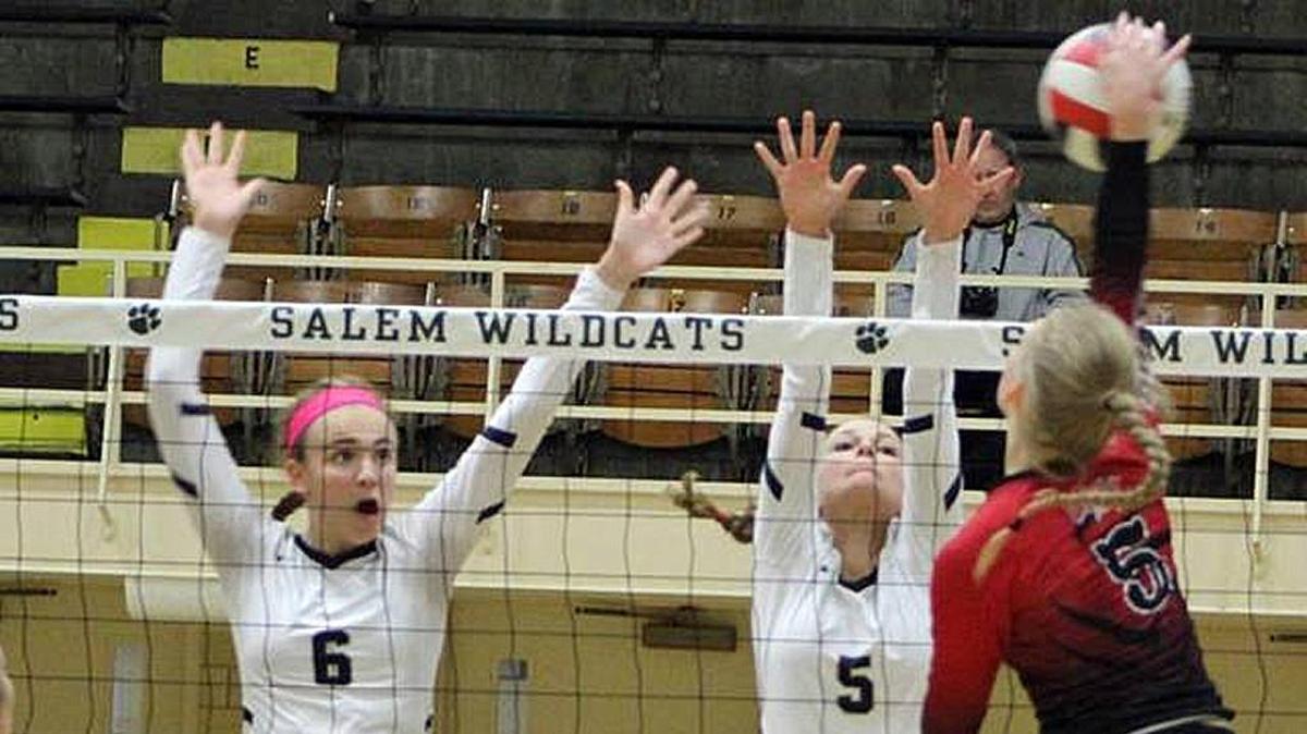 In this BND file photo, Althoff’s Karinna Gall (6) and teammate Grace Strieker go for a block against Mount Zion’s Reiley Drake during the Class 2A Salem Super-Sectional volleyball match.