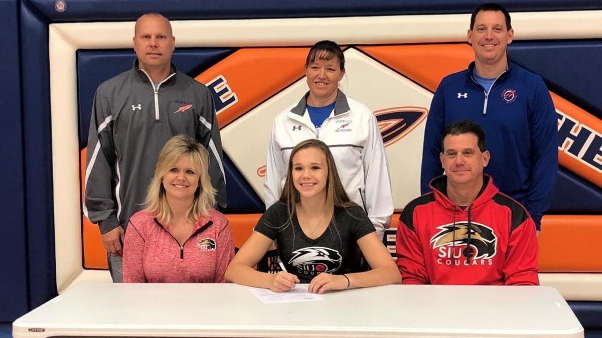 Okawville senior Madison Hackstadt (front middle) with parents Angie and Neal Hackstadt. In back (from left) is Okawville Athletics Director Jon Kraus, Okawville coach Michelle Hasheider-Burianek and Okawville Principal Keith Senior.