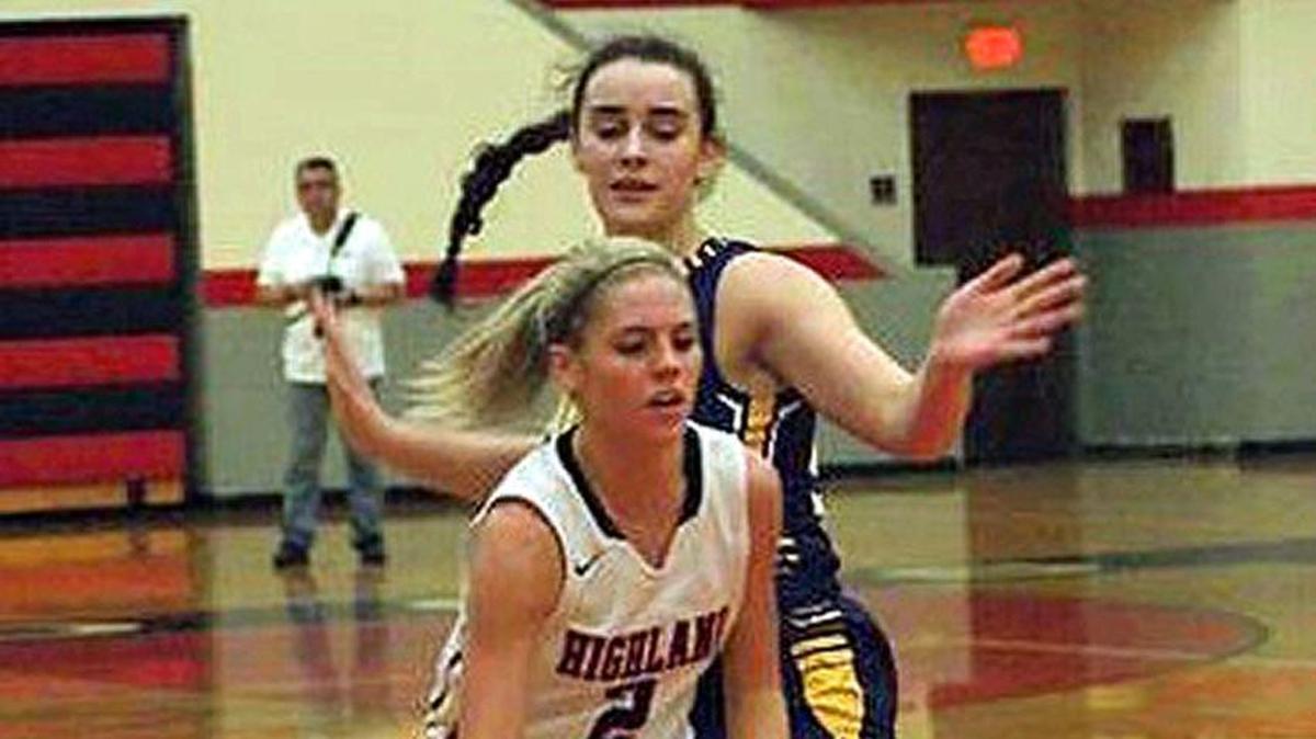 Highland senior guard Rece Portell drives by Civic Memorial sophomore Anna Hall during the second half of a December game. Both teams will be at the Highland girls tournament this weekend.