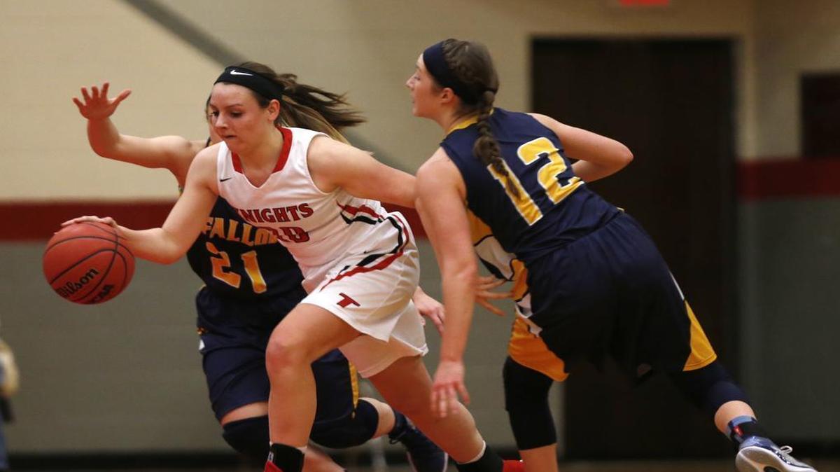 Triad's Samantha Bassler pulls away from O'Fallon's (21) Becca Althoff and Marta Durk during their game at the Scott Credit Union Highland Girls Basketball Tournament.