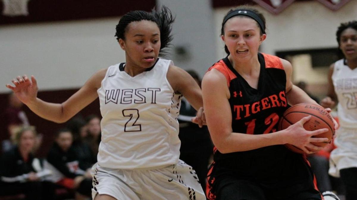 Edwardsville’s Makenzie Silvey drives past Belleville West’s Brittney Walker during their game at Belleville West on Thursday.