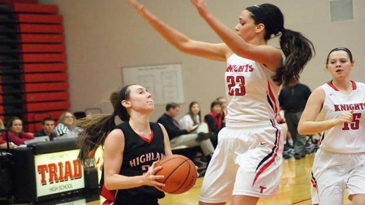 Triad senior Sophie Thompson, No. 23 in white, goes high to contest a shot attempt by Highland junior Madison Wellen.