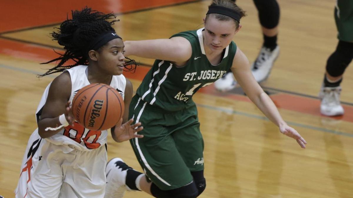 Edwardsville’s Quierra Love pulls away from St. Joseph’s Mary LaBelle during their game at Edwardsville on Wednesday.