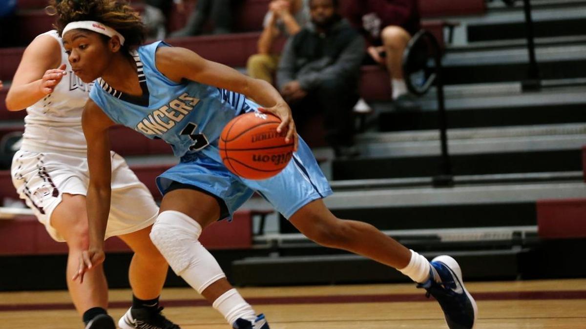 Belleville East’s Myriah Noodel-Haywood pulls away from Belleville West’s Samantha Schell during their game at Belleville West on Tuesday. See a gallery of photographs from the game at bnd.com.