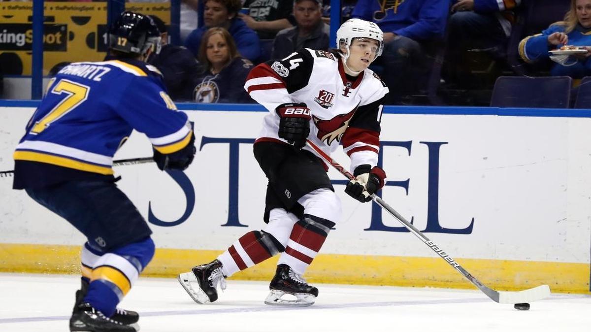 Arizona Coyotes rookie Clayton Keller (14), a native of Swansea, Ill., handles the puck as St. Louis Blues' Jaden Schwartz watches during the first period of Keller’s first NHL game on Monday at Scottrade Center.