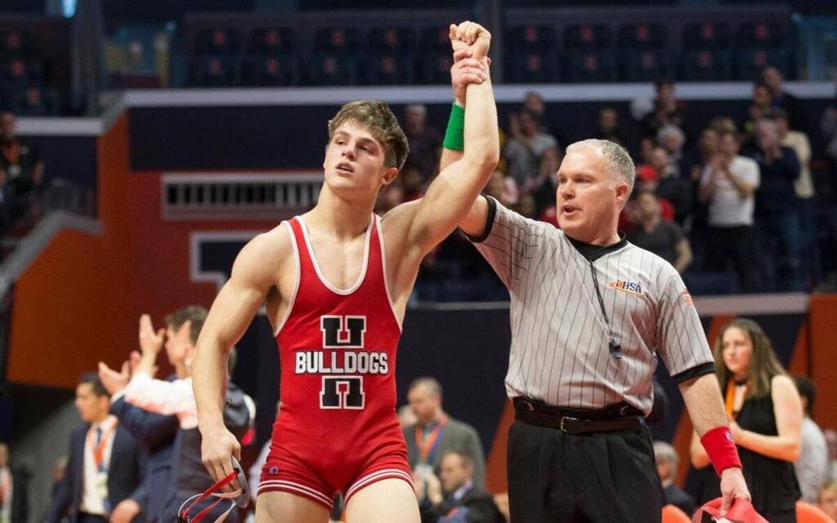 Highland’s Trent Rakers has his hand raised after winning the championship match at the Illinois High School Association state wrestling tournament in Champaign.
