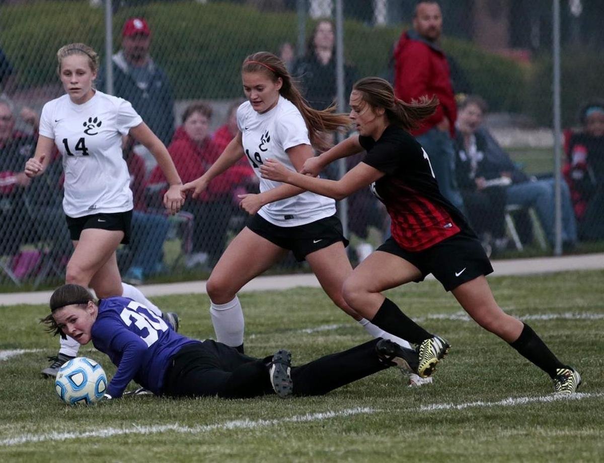 Granite City’s Bailey Barrington looks to shoot past Edwardsville goalie Regan Windau. Conference matchups between the two longtime rivals will no longer happen at the conclusion of the 2017-18 school year.