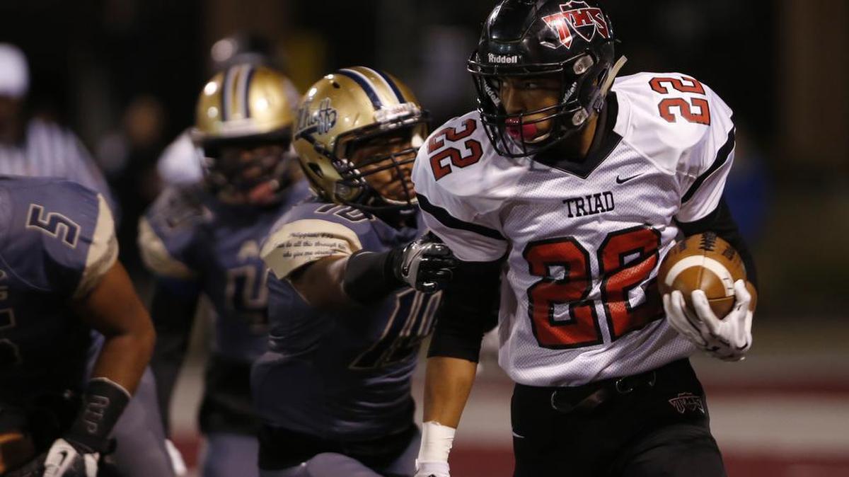Triad’s Devin Towns breaks away from Althoff’s Stephon Belt during the first half of a game last season.