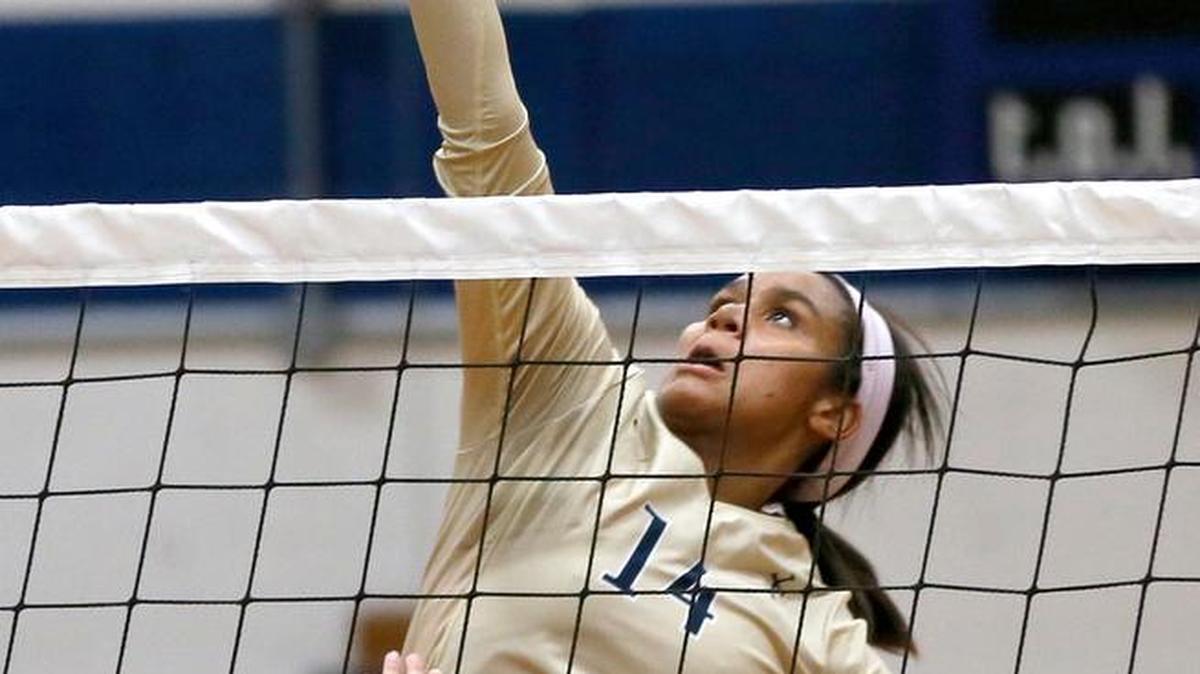 
Althoff's Alanna Bramwell goes for a kill against Mascoutah's Maddie Nekola in 2014.
