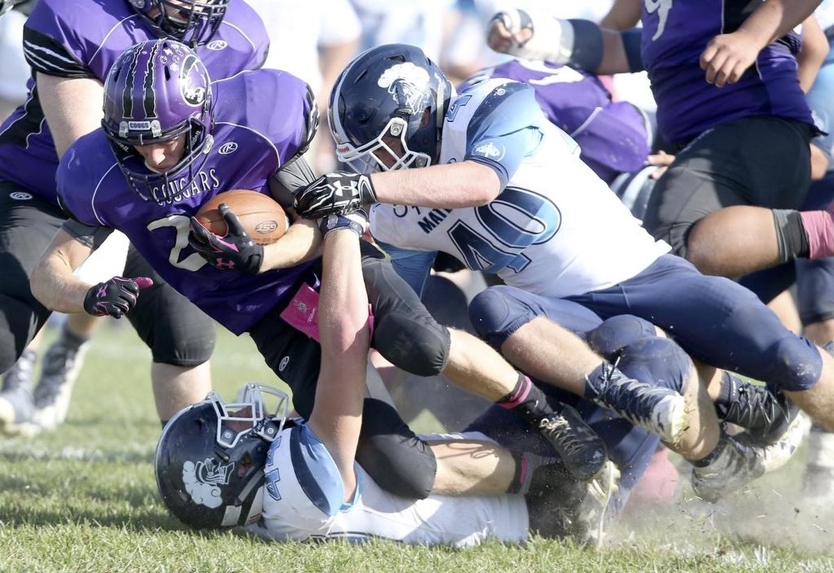 Central's Dalton Wise is brought down by Mater Dei defenders Nic Seelhoefer and Trevor Johnson during the Class 4A playoff game.