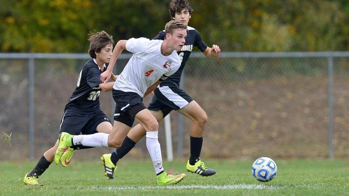 Waterloo midfielder Kane Osterhage (4) dribbles through the Carbondale defense during the 2A Boys Soccer Regional Final on Friday in Carbondale. Waterloo went on to win 3-0.