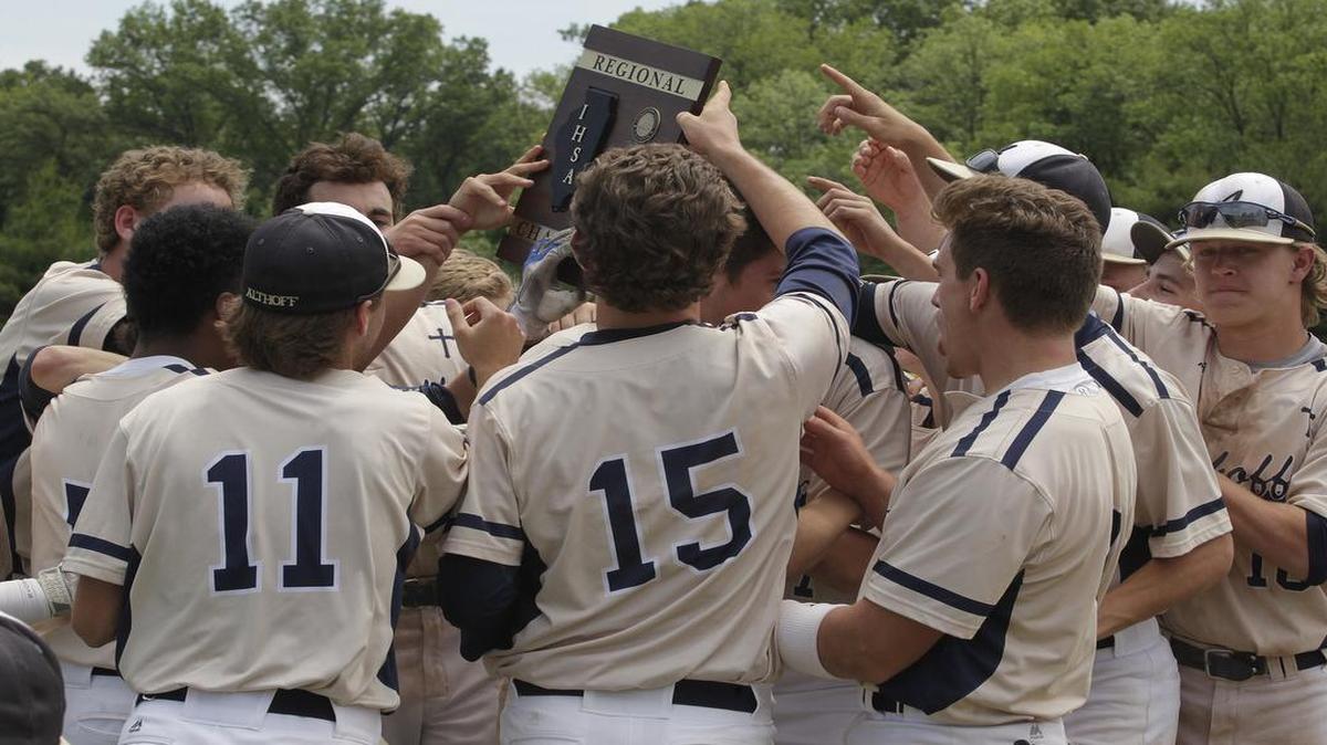 
Althoff players celebrate on the field with their regional trophy after they defeated Wesclin for the Class 2A title. 
