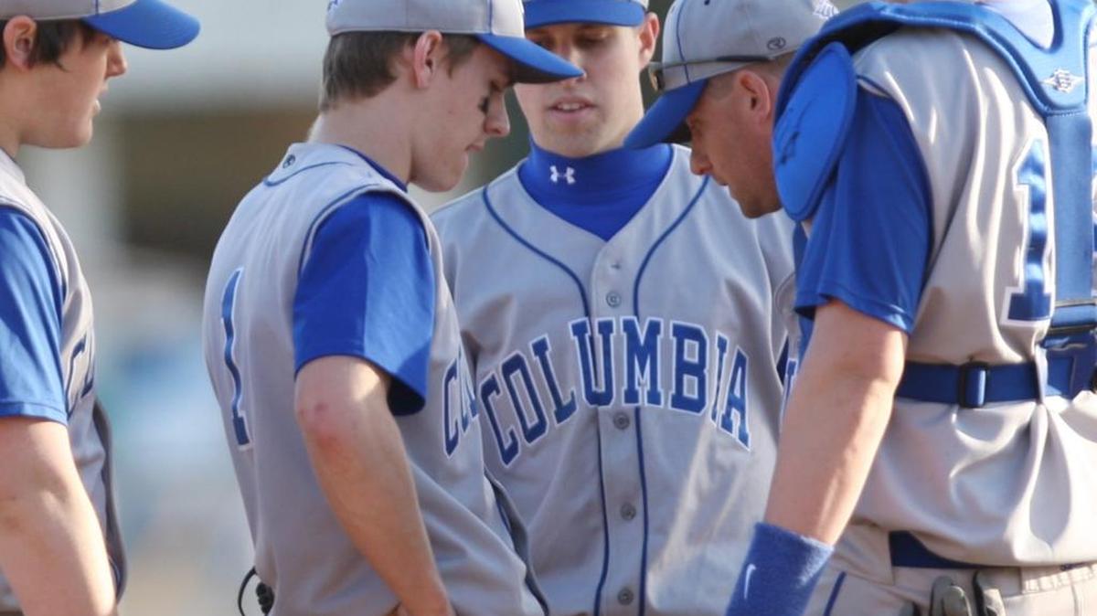 
Former Columbia coach Keith Jany (with glasses on hat in center) talks to one of his pitchers.
