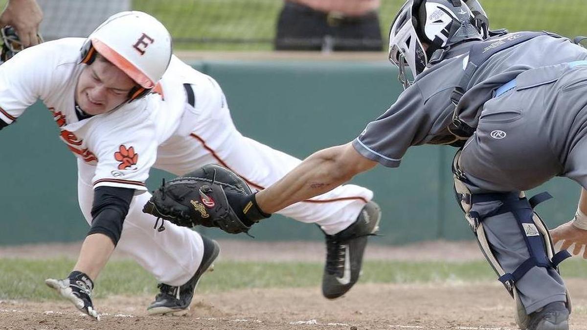 BND Large School Baseball Player of the Year Dylan Burris slides around a tag in a game against Belleville East last year.