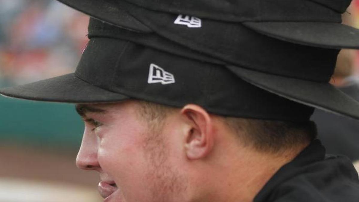 
Highland second baseman Tyler Pollard wearing the trademark “rally hat stack” Monday during the Bulldogs’ super-sectional win at Sauget
