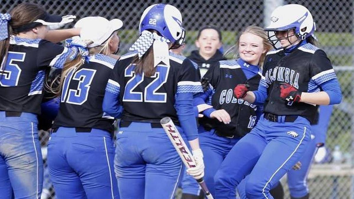 Lexi Touchette is greeted at home plate by other members of a deep Columbia lineup after she blasted a home run at Belleville East on Apirl 8.