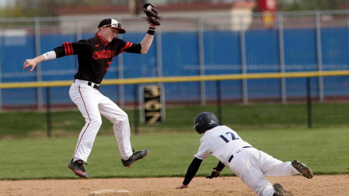 Belleville East's Zachariah Gregorian gets safely on second as Edwardsville's Andrew Yancik jumps for the ball during their game at Belleville East on Tuesday.