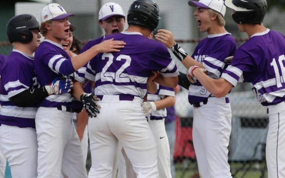 Easton Wallace, No. 22, is greeted by Valmeyer teammates at home plate during a regional championship win.