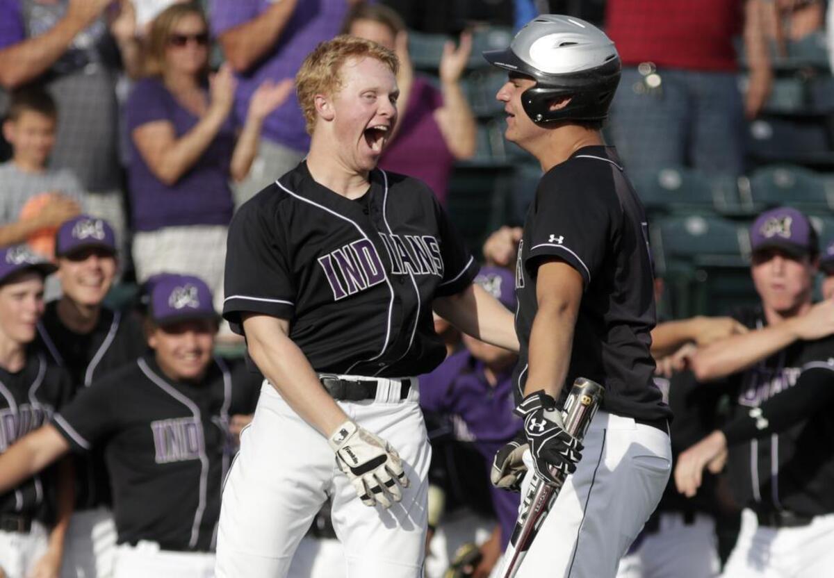 Mascouah’s Austin Wombacher celebrates his two run homer during theirduring their Class 3A Supersectional against Champaign on Monday.