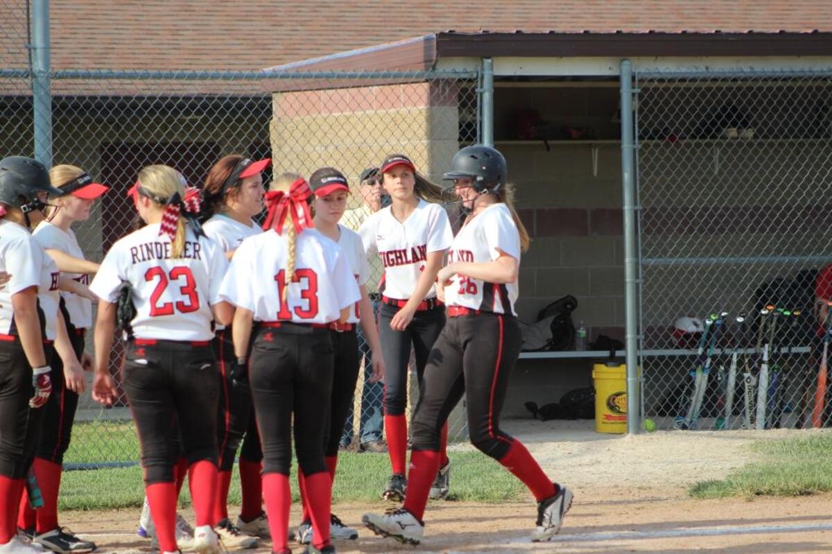 Highland junior Lauren Baer is greeted by teammates at home plate after belting her sixth home run of the season, a fifth-inning blast in a win over Triad Monday.