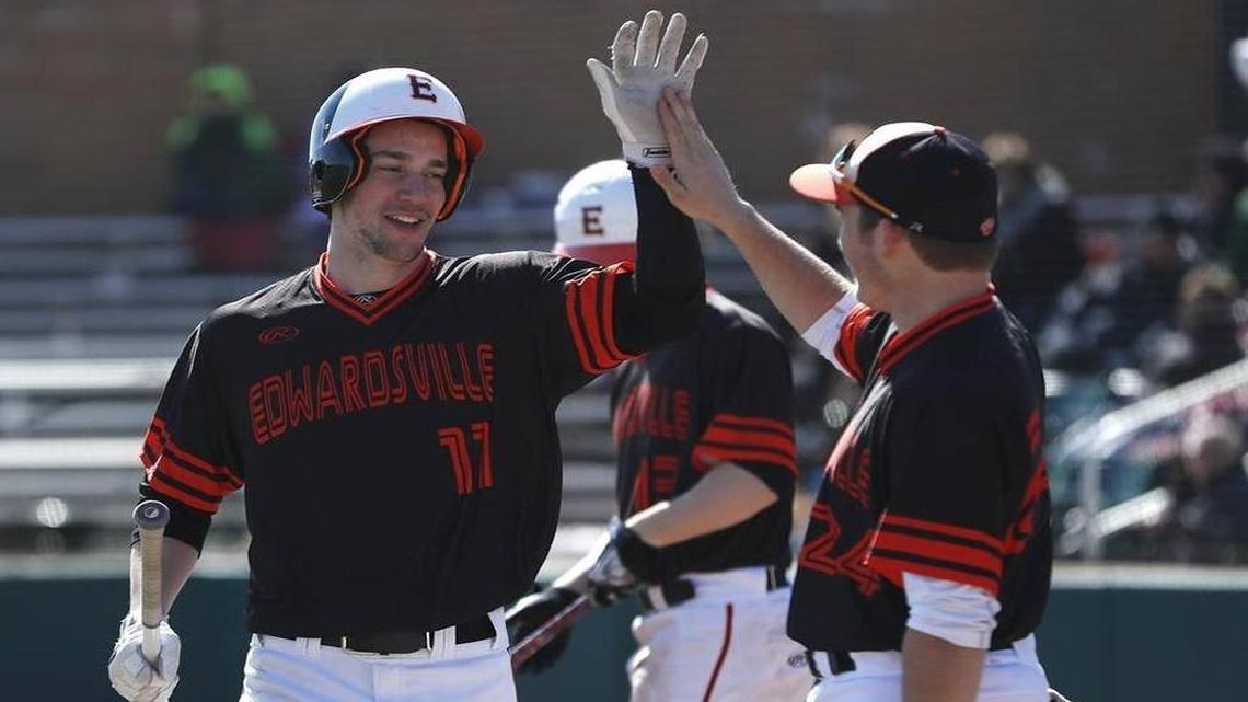 Edwardsville’s Dan Picchiotti is congratulated by his teammate Reid Hendrickson after he scores during their game against Joliet Catholic at the Metro East Kickoff Classic at Edwardsville High School in March. The Tigers face St. Laurence in the IHSA Class 4A baseball semifinals in Joliet Friday.