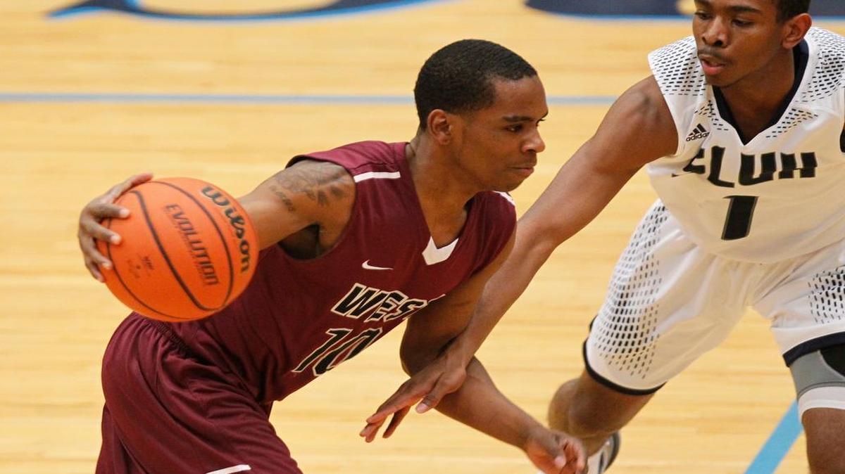 St. Louis University High’s Mikey Sanders Jr. closes in on Belleville West’s DeAndre Jackson during their game Thursday. See a gallery of photographs of the games at bnd.com.