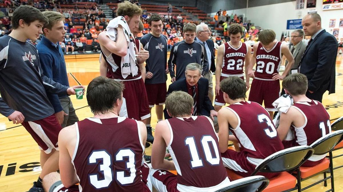 Gibault Hawks coach Dennis Rueter (center) collected his 700th career win Friday in the Hawks’ 41-26 home victory over Mascoutah.