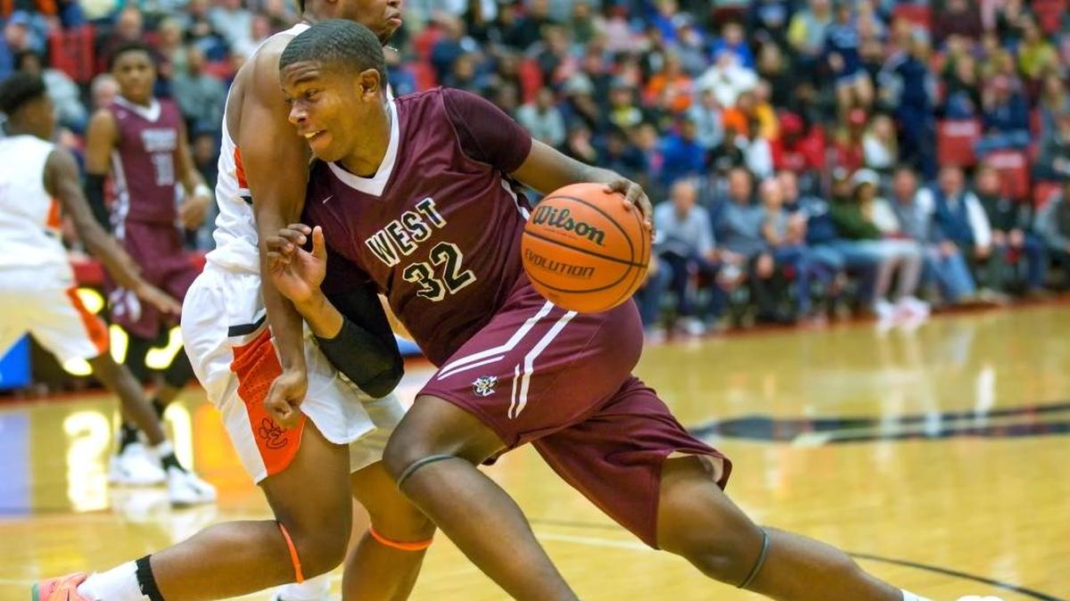 Belleville West’s EJ Liddell drives against Edwardsville’s RJ Wilson during Saturday’s SWC event at SIUE’s Vadalabene Center.