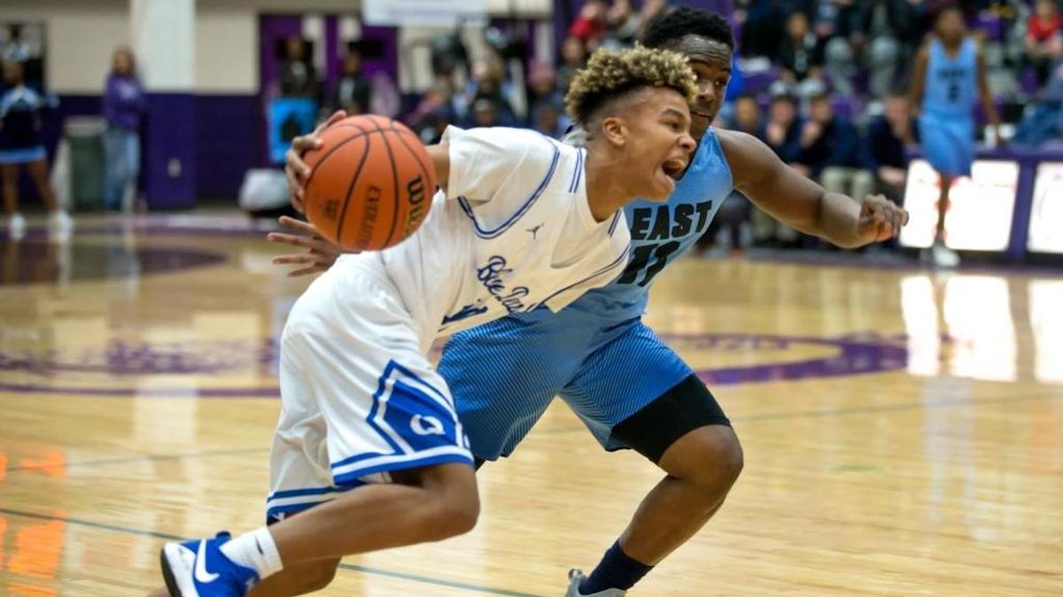 Quincy’s Jaeden Smith drives against Belleville East’s Kienen Waller during Thursday’s Collinsville-Prairie Farms Holiday Classic basketball tournament at Collinsville High School.