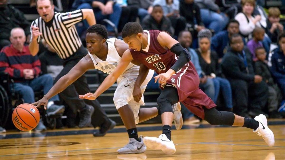 Belleville West junior Lawrence Brazil III (10) battles East’s Kienen Waller for the ball during a Southwestern Conference game Friday. Brazil is averaging 11 points per game this season.