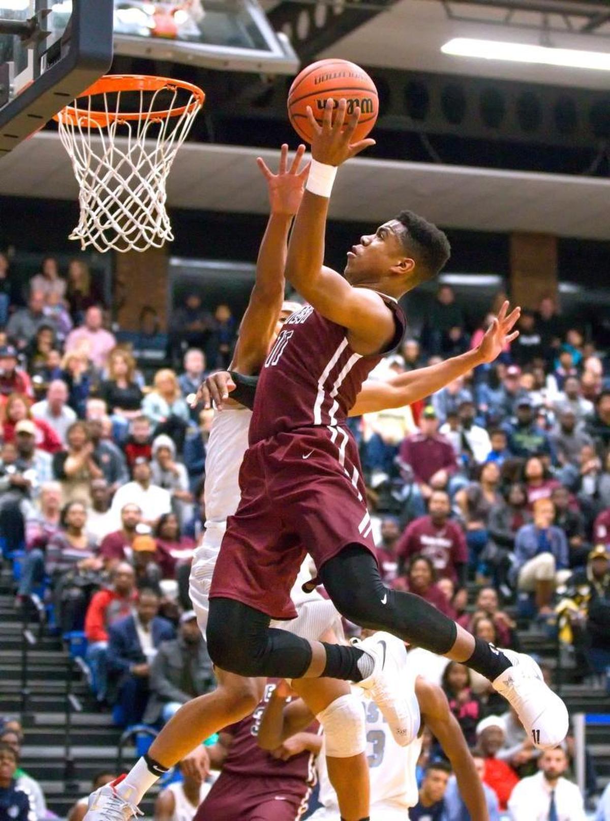 Belleville West’s Malachi Smith goes up for an easy two points against Belleville East during Friday’s Southwestern Conference game at Belleville East High School.