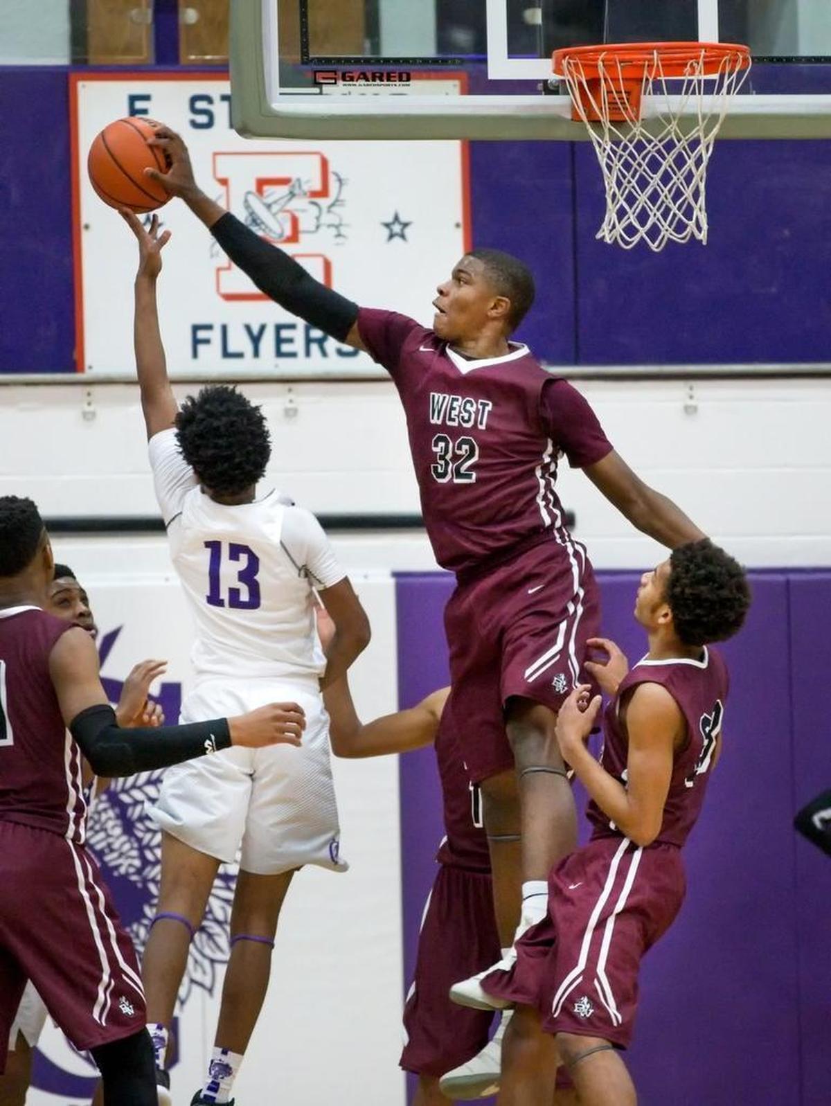 Belleville West’s EJ Liddell blocks a shot by Collinsville’s Ray’Sean Taylor during Friday’s Southwestern Conference game at Collinsville High School.