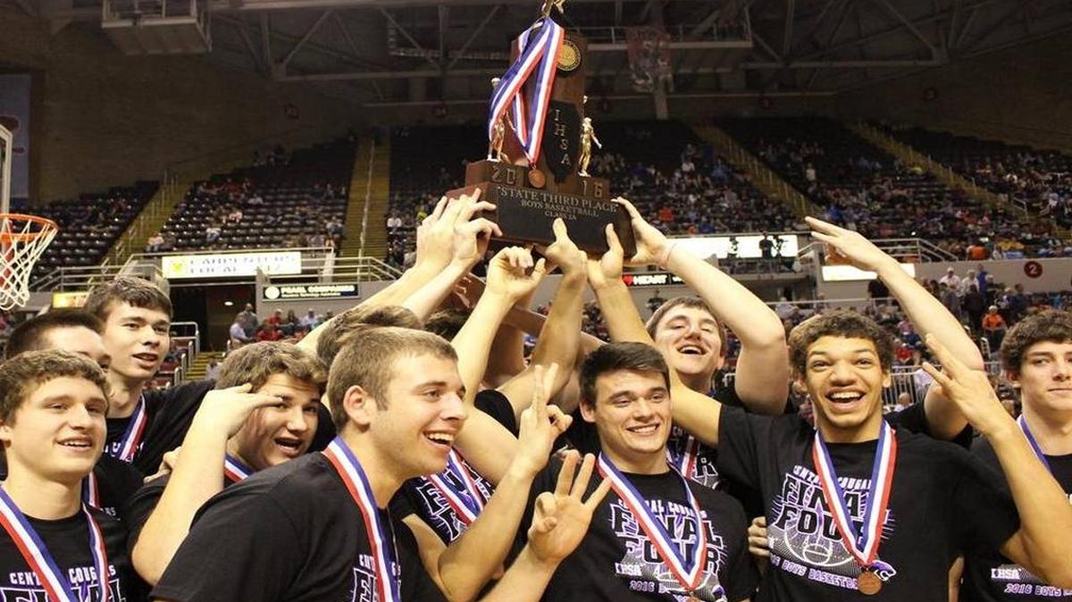 The Central Cougars celebrate with their trophy after winning third place last season at the Class 2A boys state basketball tournament.