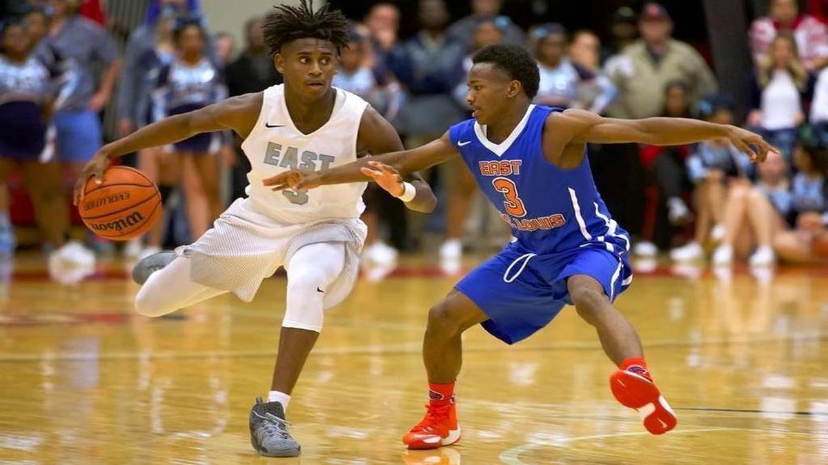 Belleville East guard Rico Sylvester being defended by East St. Louis guard Marrion Chairs on Saturday during East St. Louis’ 84-77 victory over East at SIU Edwardsville
