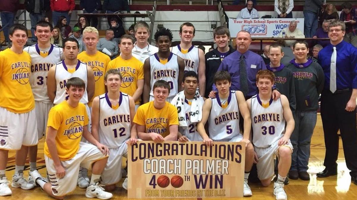Carlyle coach Andy Palmer (near right, purple shirt) surrounded by his team after picking up his 400th career win last week at the Benton Invitational Tournament.