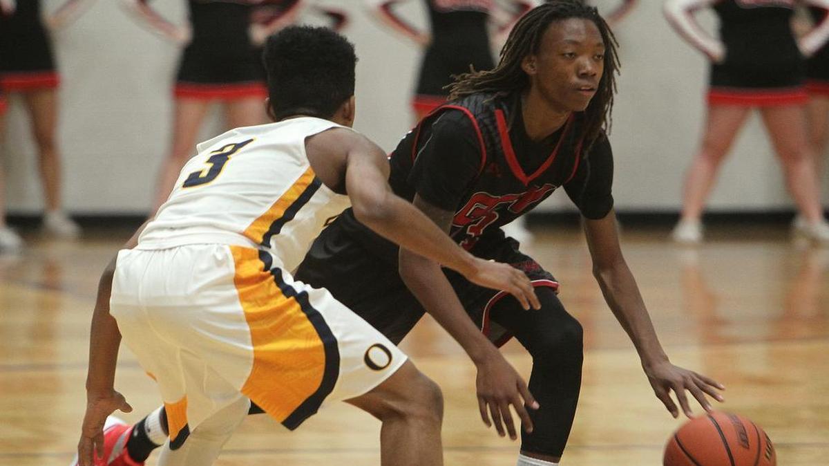 Granite City's Niklaus Wilkins (23, right) dribbles downcourt as he's guarded by O'Fallon player Ryan Fulton (3) in the first half.