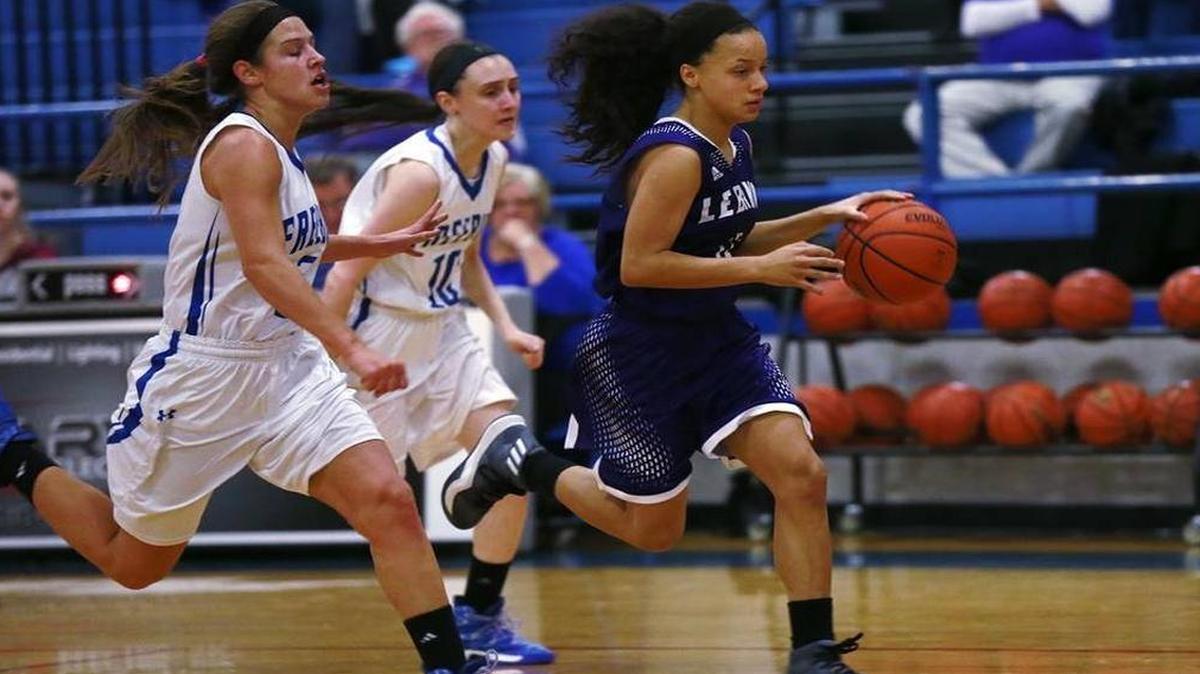 Lebanon's Krista Bass pulls away from Freeburg's (2) Kayla Whitworth and Lilly Oliver during their game at Freeburg in December. With a championship win in their own holiday tournament, the Greyhounds held on to the No. 1 spot in the Illinois Class 1A girls basketball poll.