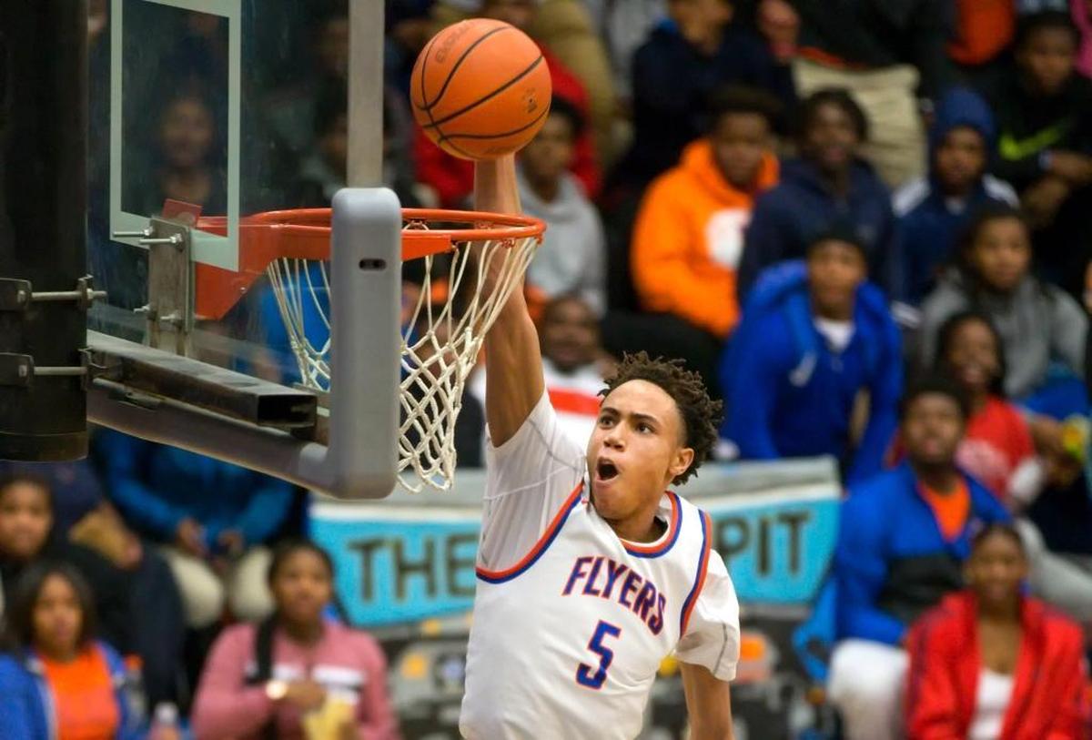 East St. Louis’ Joe Reece goes for the slam dunk against the Edwardsville Tigers during Wednesday’s Southwestern Conference game at East St. Louis Senior High School.